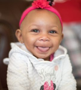 Happy baby with tongue out